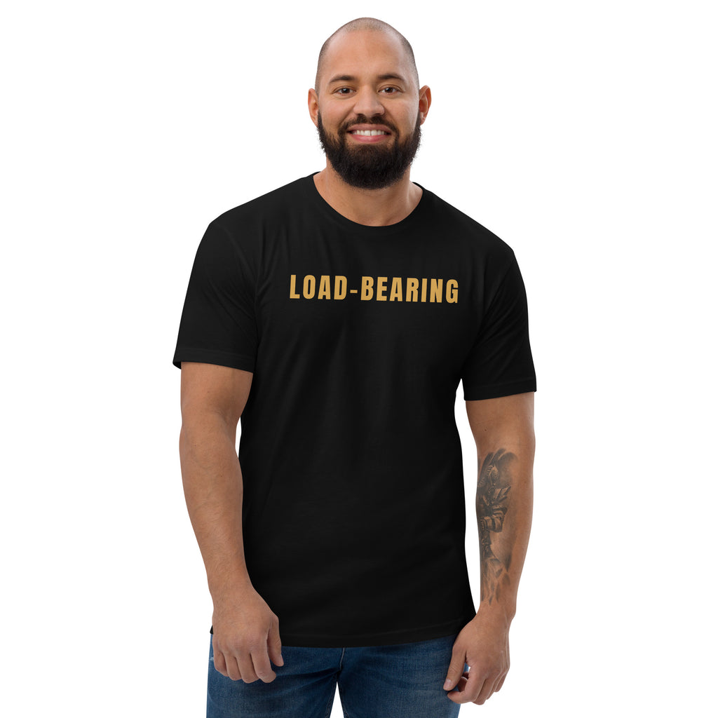 Load-Bearing T-shirt worn by a smiling bearded man, gold LOAD-BEARING across the chest