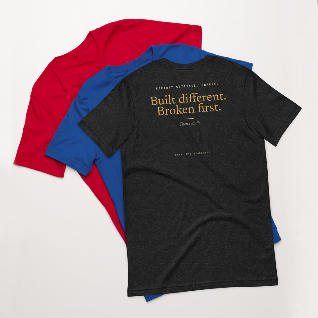 Built Different T-shirt, Black Heather, back: Built different. Broken first. Then rebuilt.