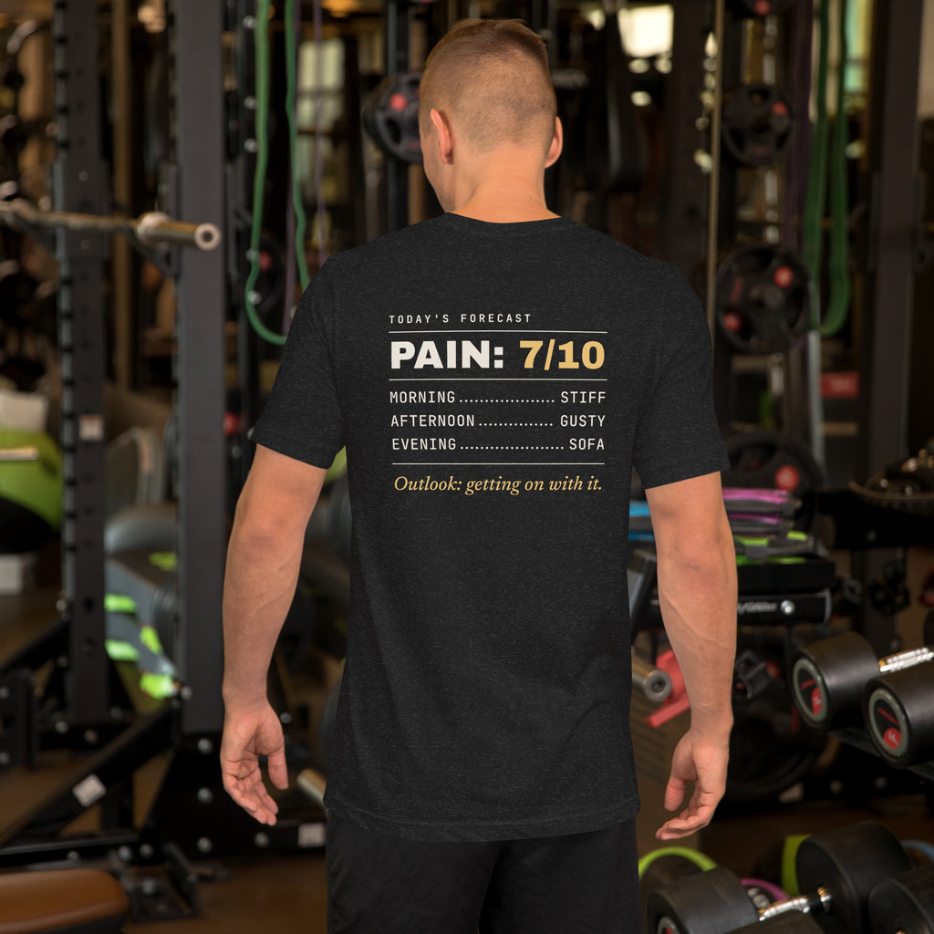 Pain Forecast T-shirt worn in a gym, back print: Today's forecast. Pain 7/10. Morning stiff, afternoon gusty, evening sofa. Outlook: getting on with it.